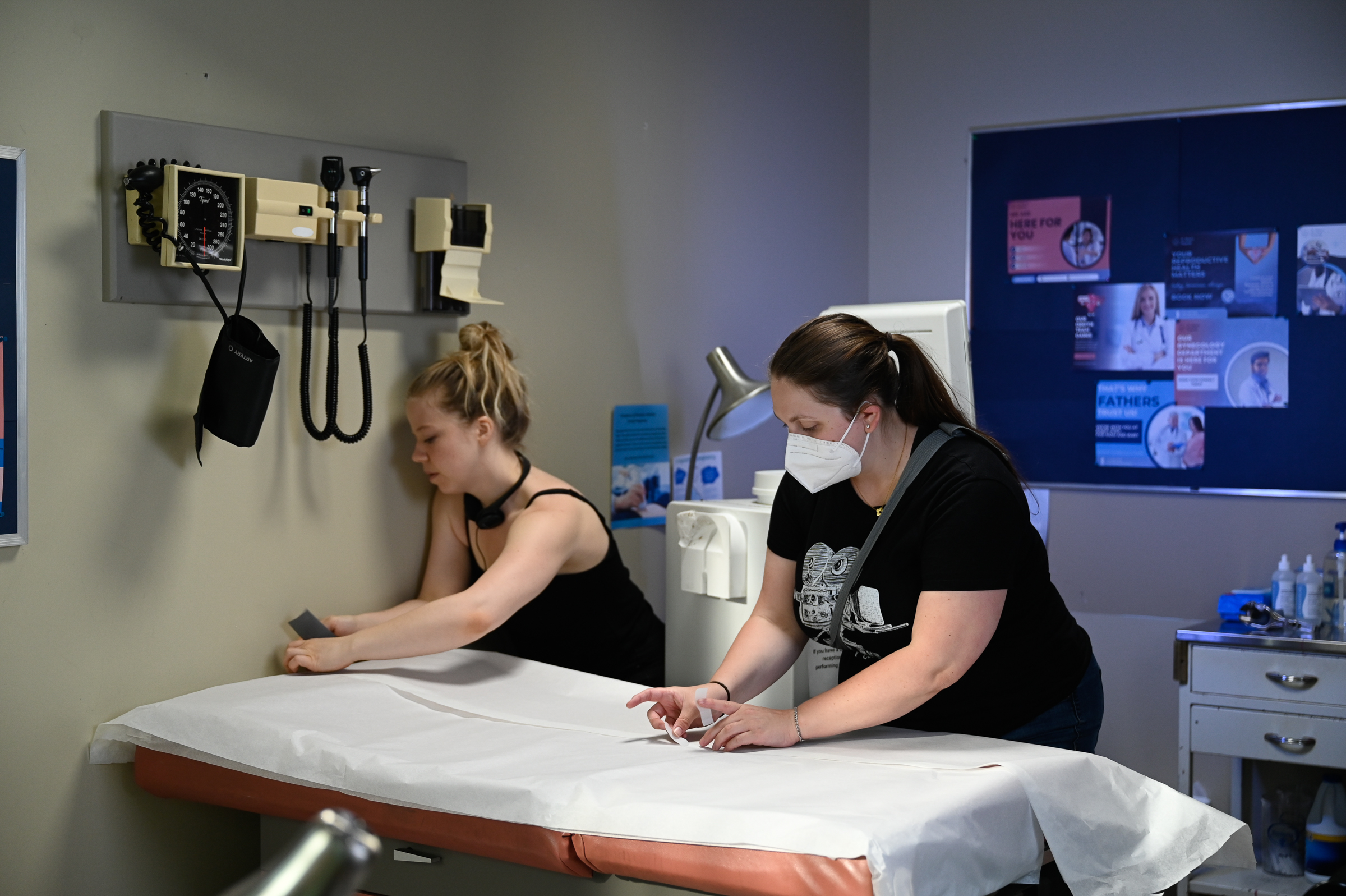 Photo of Vivien and Vickie dressing up the bed in the set.