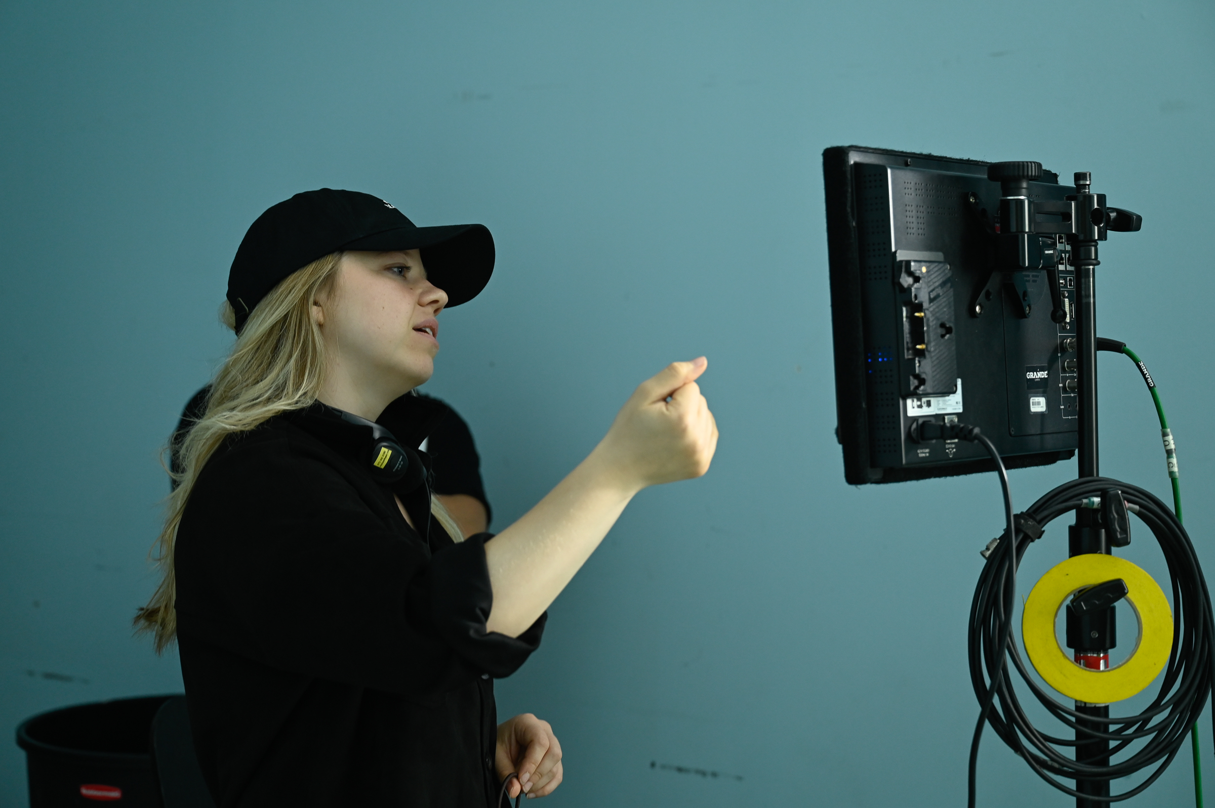 Vivien looking at the camera monitor and providing directions